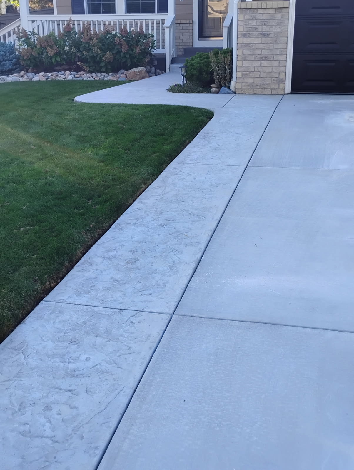 Concrete driveway with textured border and matching sidewalk